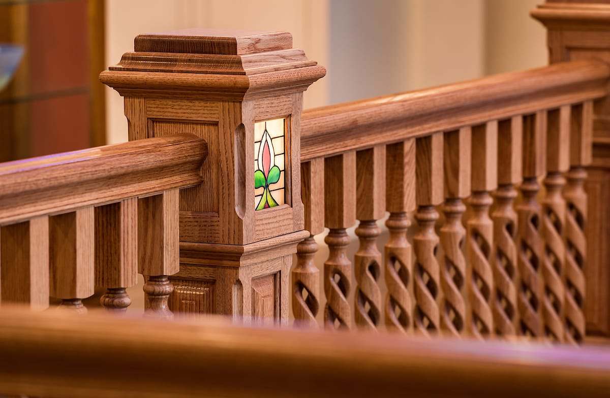 Unique turned balusters with a ribbon style detail and square newel with routed details