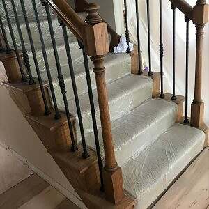Staircase with Wood Newels and handrail paired with iron balusters