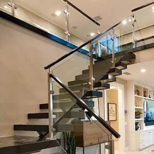 Floating wood stair treads with glass panels under handrail