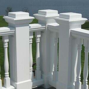Stair Parts- White square newels and turned spindles on an exterior deck