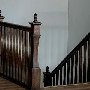 Custom square profile newel with small finial and custom square twisted balusters
